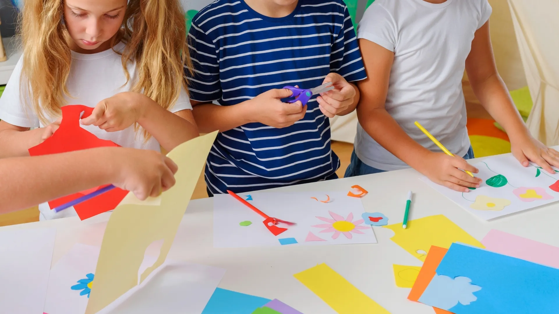 close-up of children's hands making art and crafts