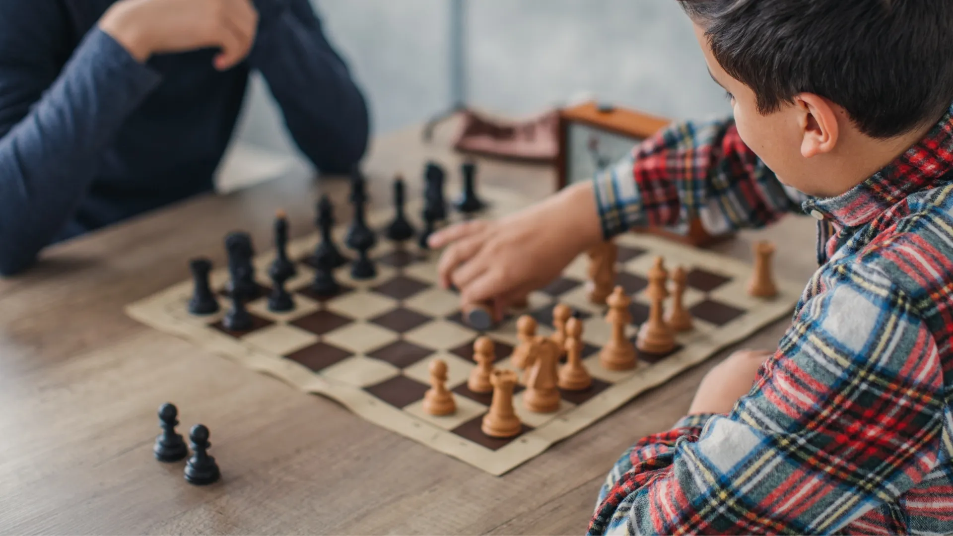 close up of two people playing chess