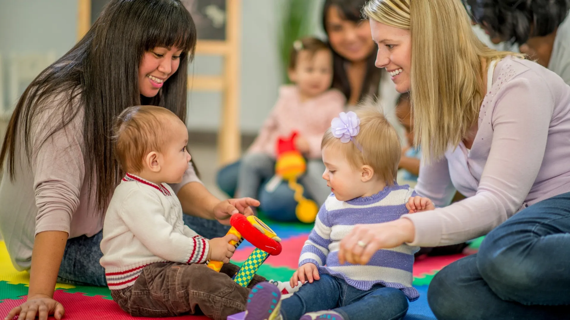 two mothers and two children playing with toys