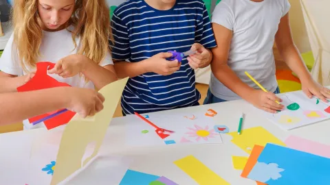 close-up of children's hands making art and crafts