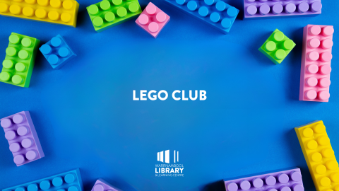 Flat lay of colourful lego scattered on a blue background