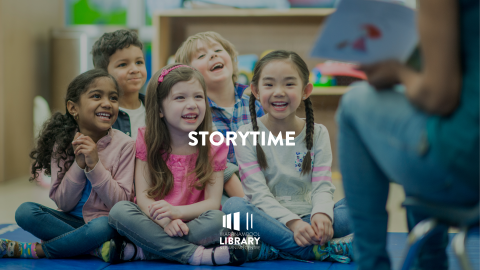 group of children sitting on floor listening to book being read