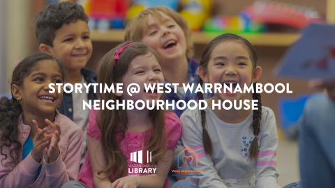group of children sitting on floor laughing while being read to