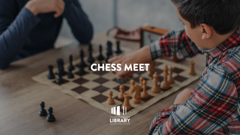 close up of two people playing chess